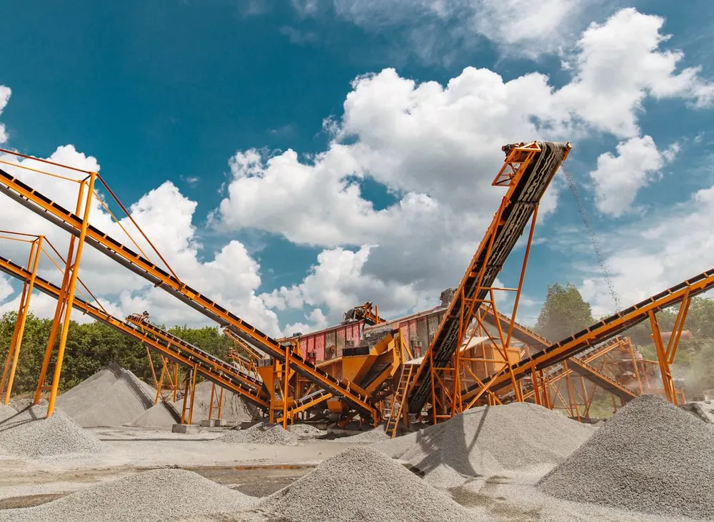 Conveyor stackers above stockpiles of crushed stone aggregate