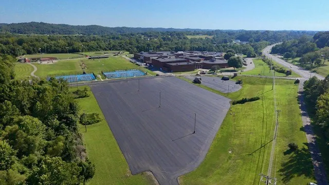 Aerial view of a freshly paved parking lot beside athletic fields